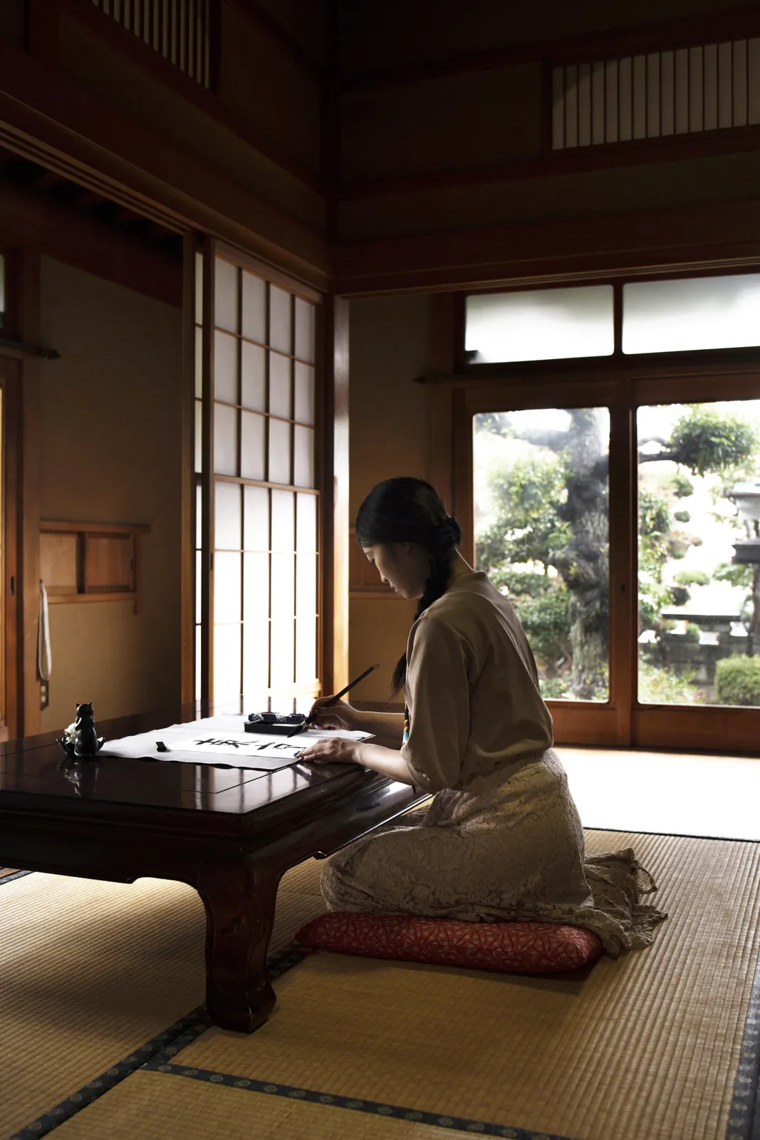 A learner studying at a low desk